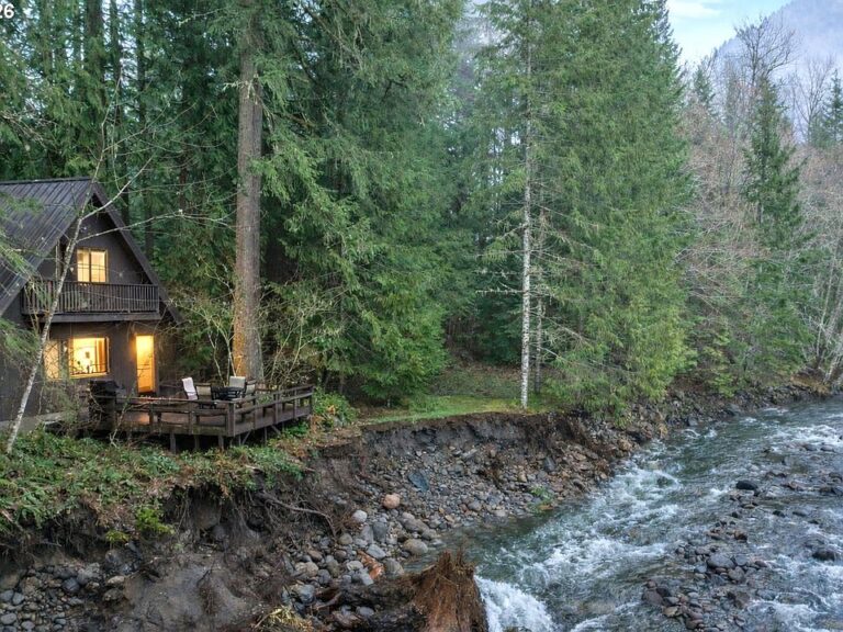 Pretty stone fireplace! C. 1971 riverfront escape in Oregon. $499,000.