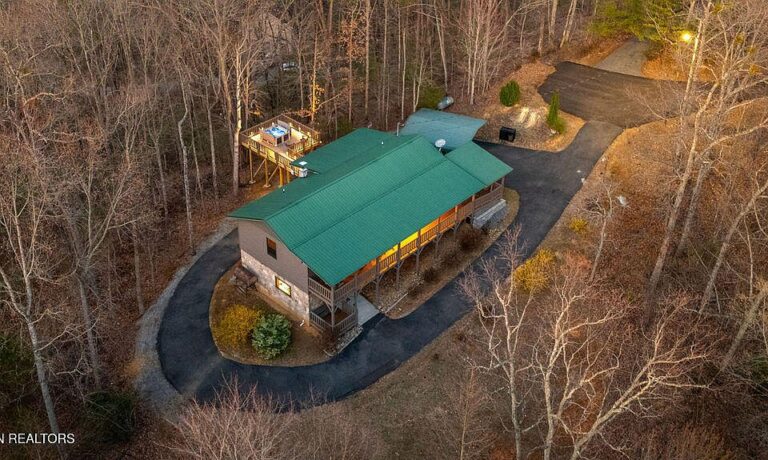 Pretty wooded setting and a hot tub! C. 2005 in Sevierville. $850,000.