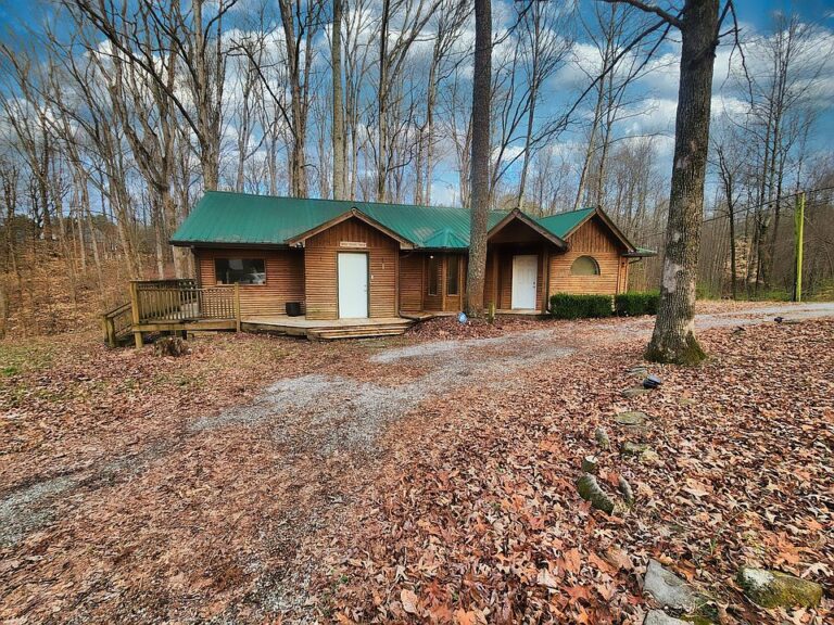 Check out that deck!! Woodsy resort vibes on .72 acres in TN. $259,000.