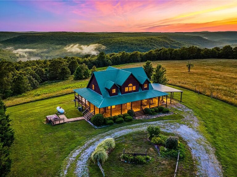 Pretty porch and setting! Custom home on over 100 acres in Arkansas. $1,150,000.