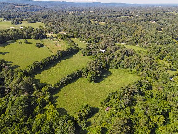 Check out that river frontage!! Log cabin retreat on 58 acres in Sparta. $1,109,999.