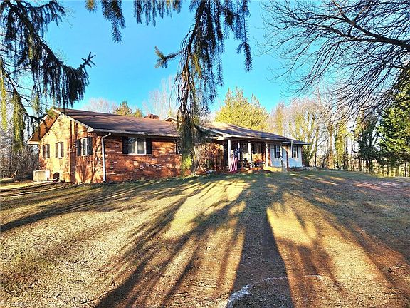 Bonus log cabin! Brick ranch on nearly 8 acres in NC. $355,000.