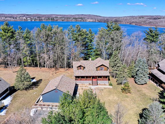 Check out the woodwork!! Floor-to-ceiling logs and 114ft of waterfront in Dresser. $550,000.