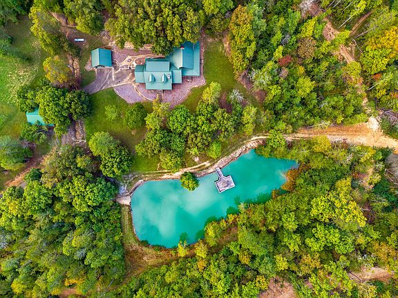 Pretty wood beams and lake views! C. 1993 log estate in Mooresburg. $3,000,000.