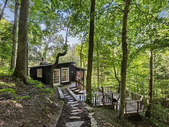 Check out the fireplace!! Historic 1930s log cabin on 105 acres in Tennessee. $749,000.