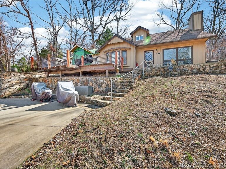 Check out the lake views!! 10×20 boat slip included in Missouri. $198,000.