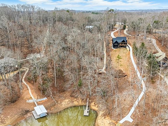 Lakefront treehouse vibes! Custom waterfront home on 2 acres in SC. $799,000.