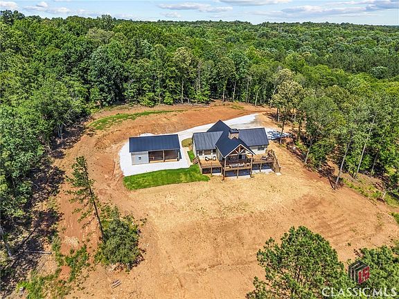 Pretty kitchen and porches! Modern farmhouse on 5+ acres in Danielsville. $524,900.