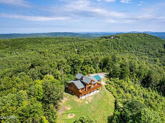 Check out that porch! Mountain top serenity in Tellico Plains. $949,000.