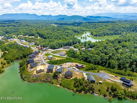 Pretty Stone Fireplace! C. 2024 Luxury Cabin on the Water. $1,050,000.