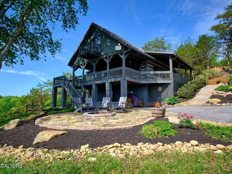 Pretty lakefront setting! Log cabin on one acre in Tennessee. $1,190,000.