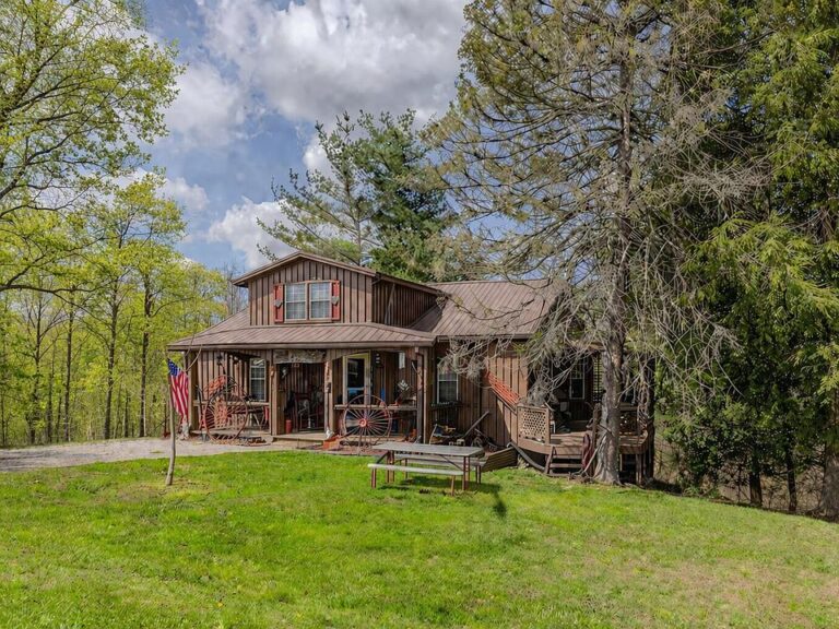 Check out the wraparound deck! 15 wooded acres in Kentucky. $268,000.