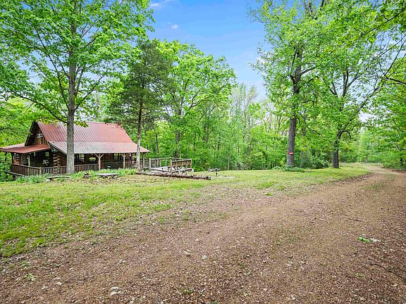 Pretty cabin and creek! Nearly ten acres in Arkansas. $209,000.