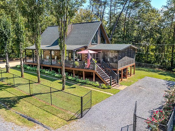 Pretty porch and river access! Over two acres in Tennessee. $499,900.