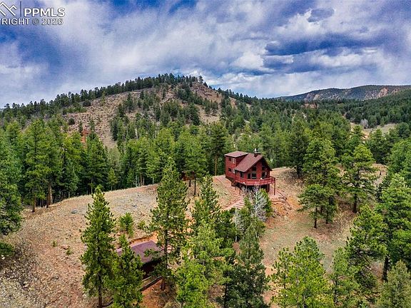 Mountain chalet vibe and wall of windows! 2.2 acres in Colorado. $539,000.