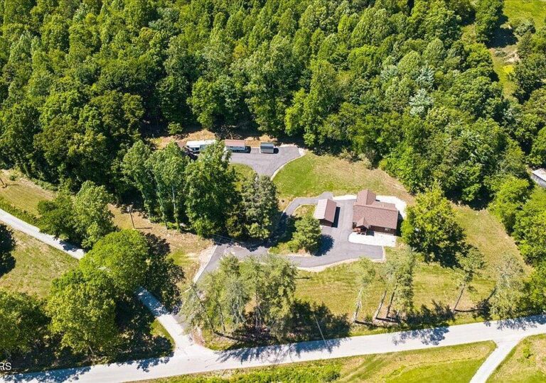 Massive covered porch! 17 mountain acres in Tennessee. $748,500.