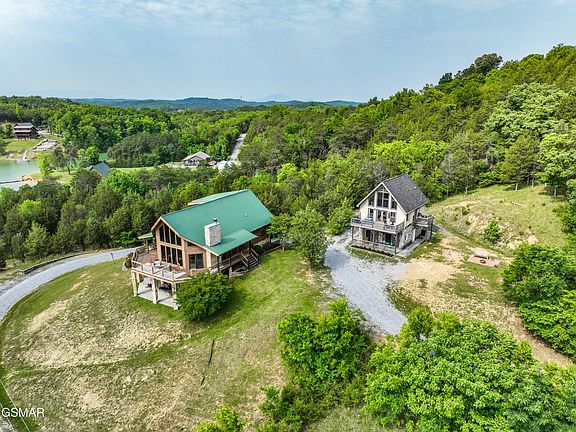 Check out the private dock! Log cabin retreat on 6 acres in Tennessee. $1,395,000.
