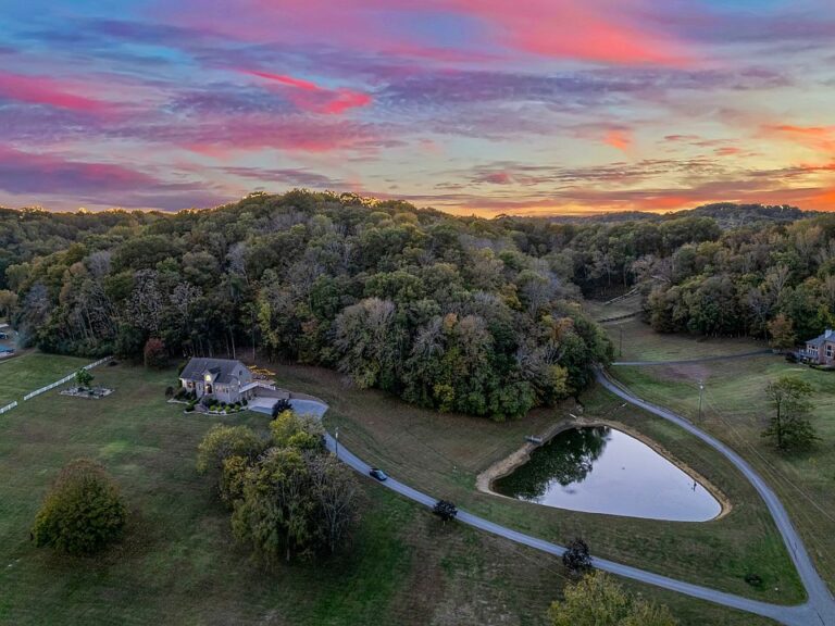 Stunning staircase and soaring ceilings! Over 15 private acres in Tennessee. $1,899,999.