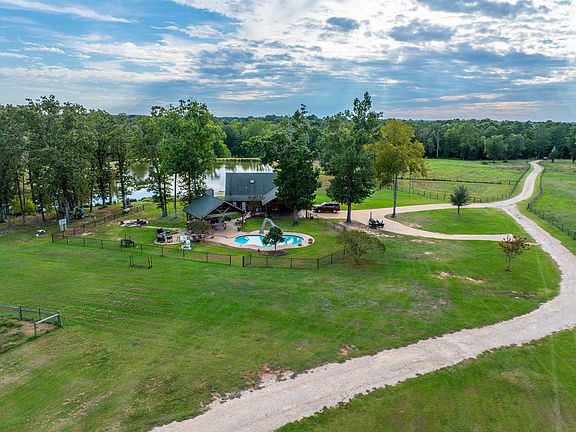Private lake and 73 acres! C. 2012 Log Cabin in Texas. $699,900.