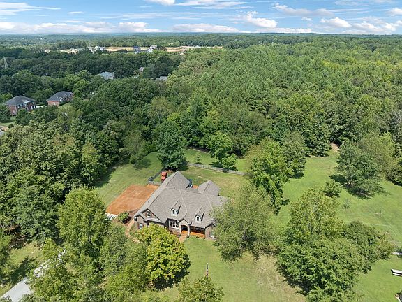 Gourmet kitchen and gated privacy! Over 12 lush acres in Tennessee. $2,499,000.