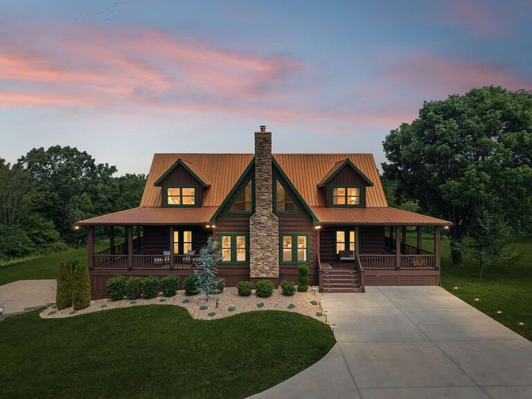 Custom log home luxury and a stunning stone fireplace! Over nine acres in TN. $1,650,000